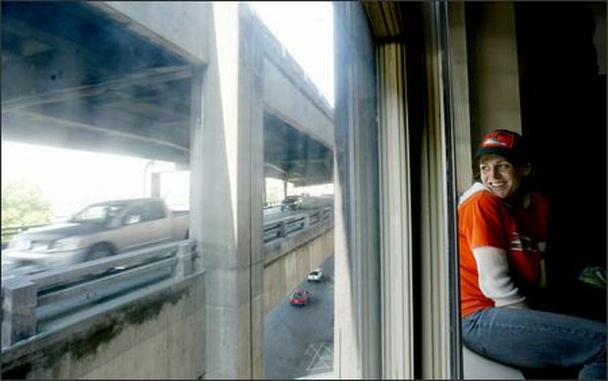 Liz Fairbanks, 31, a longshoreman, looks at the Alaskan Way Viaduct just outside her apartment in the OK Hotel. Tearing down the viaduct would give her a waterfront view.