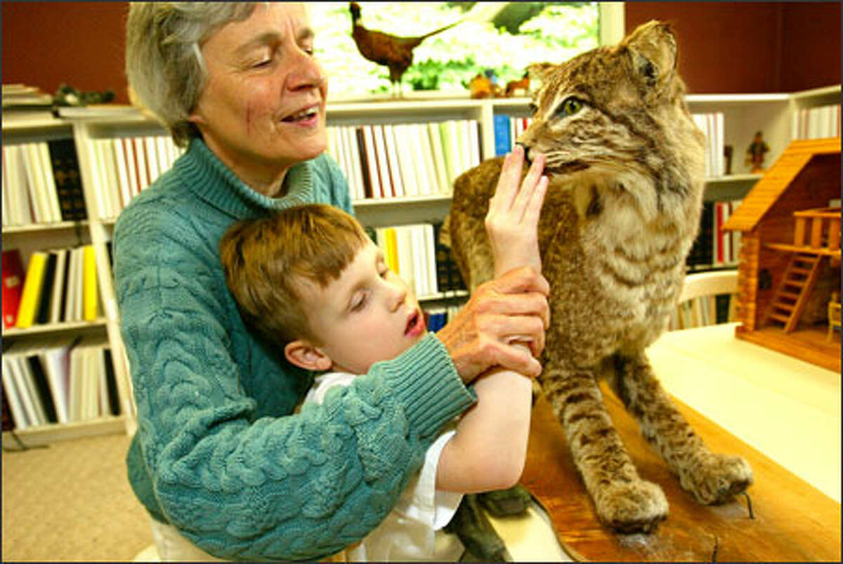 Carolyn Meyer, director of the Louis Braille School in Edmonds, introduces Tristan Freckleton, 5, to a stuffed bobcat. The school provides a summer camp for blind youngsters, teaching them life skills and how to deal with their impairments. The new K-8 school will welcome students for the first time in September.