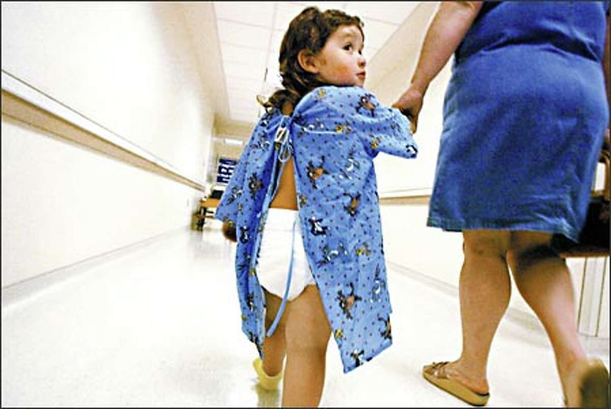 Angelito Haney, age 2, heads down the hallway at Children's Hospital for dental surgery accompanied by his mother, Tammy Haney. Pediatric dental surgery is one of the most common surgeries performed at Children's Hospital, with many families traveling from as far away as Wyoming for care.