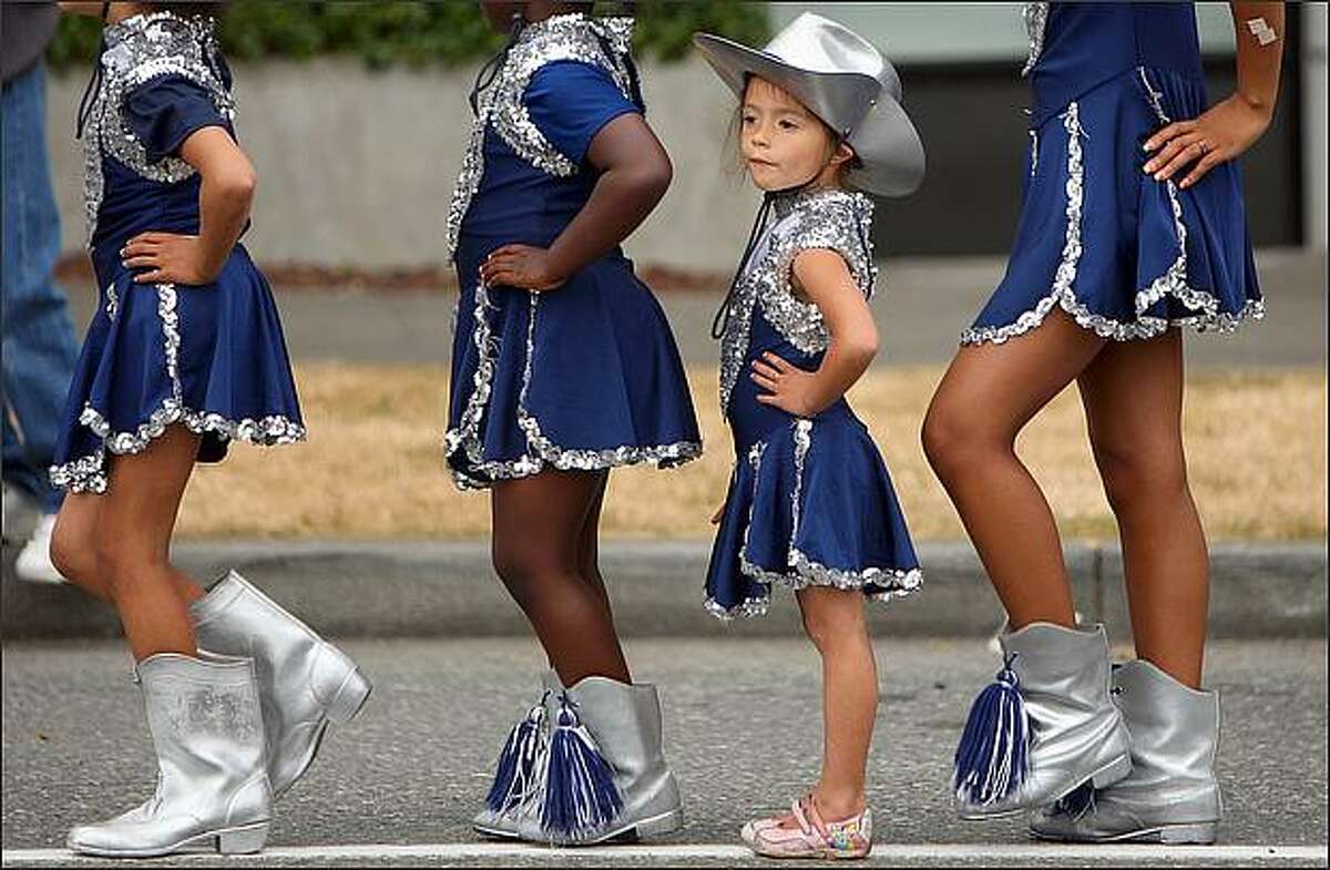 Angel Ferret, 4, from Lakeside, Wash., lines up with fellow members of the Northside Drill Team at the Greenwood Seafair Parade. (Staff Photo/Seattle Post-Intelligencer/Mike Kane)