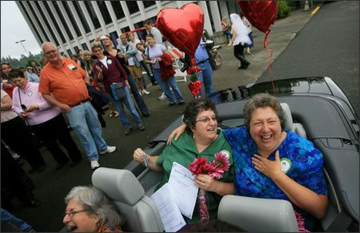 Lisa Brodoff, left, and Lynn Grotsky are all smiles after getting into a convertible to begin their celebration after registering as domestic partners in Olympia, WA on Monday, July 23, 2007. The couple, from Lacey, have been together for 26 years.