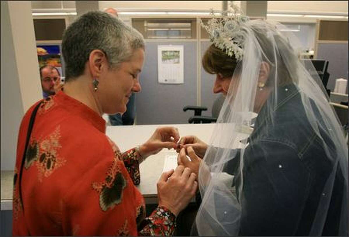 Danni Sabia, left, Claudia Wheatley of Olympia exchange rings after registering as domestic partners in Olympia, WA on Monday, July 23, 2007.