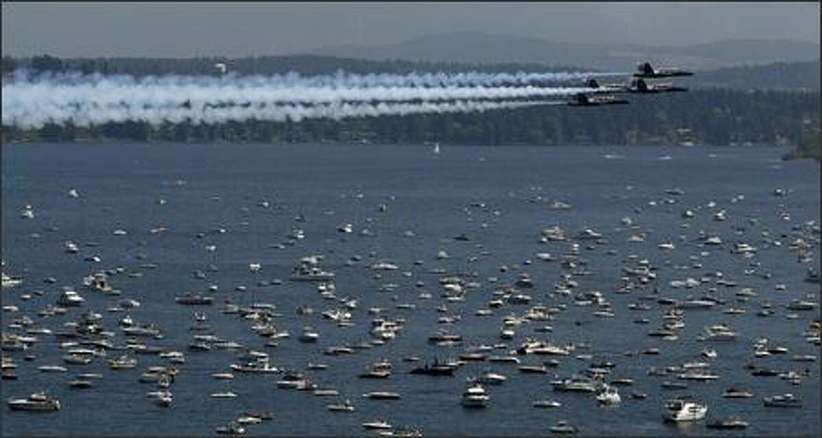 The Blue Angels buzz the boats over Lake Washington in a view from Madrona in Seattle.