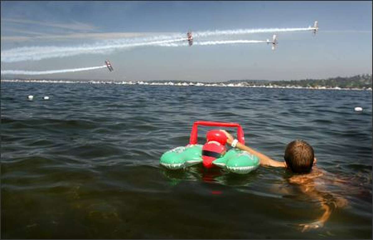 Cody Sellmann watches the Red Baron Pizza Squadron perform over Lake Washington.