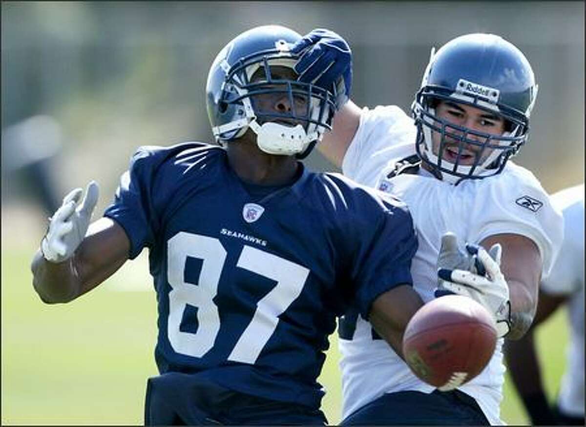 Seattle Seahawks middle linebacker Lofa Tatupu breaks up a pass intended for rookie receiver Ben Obomanu (87) on Thursday at training camp in Cheney.