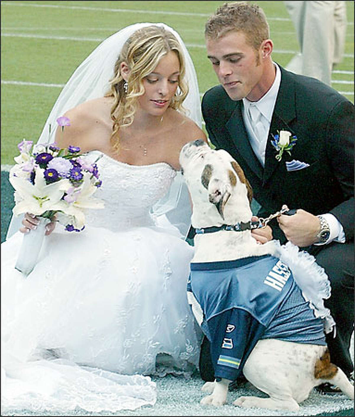 With Fumbles, their 8-month-old bulldog, serving as ring bearer, rabid Seattle Seahawks fans Chris Lundberg and Alexis Russo were married Sunday night in the first-ever wedding on the field at Qwest Field.