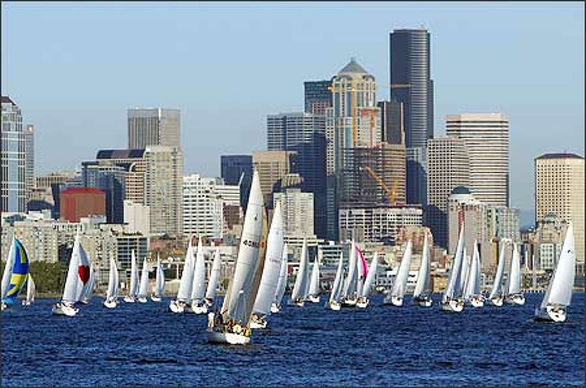 More than 70 sailboats head toward Seattle’s high-rises before making the first turn Thursday evening in the 12th and final round of this summer’s Downtown Sailing Series on Elliott Bay.