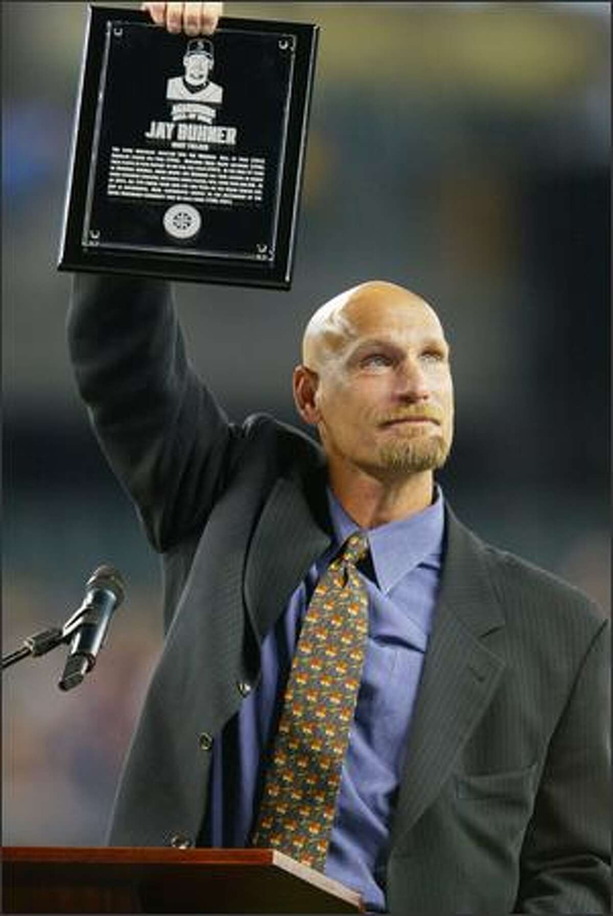 Jay Buhner shows his plaque to the crowd at end of the ceremony.