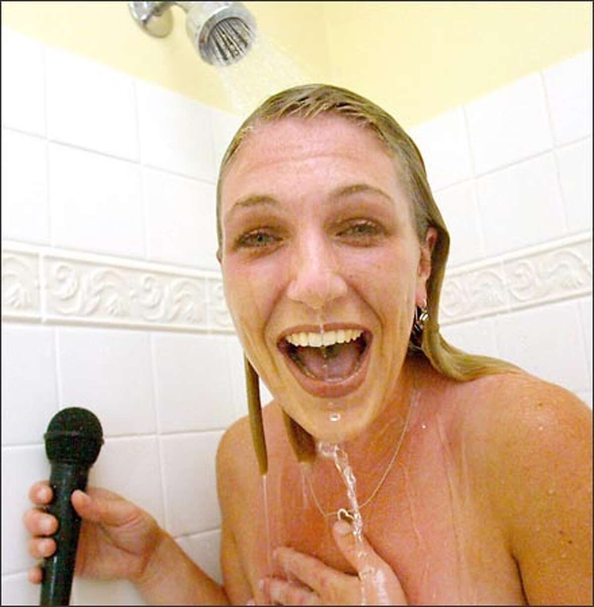 Julie Gatz, winner of the American Standard company's shower-singing contest, practices "Fly Me to the Moon," which she hopes to include on her new CD.
