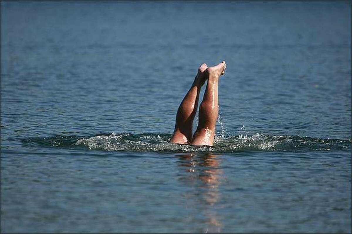 Robert Prine of Ballard swims in Green Lake. Prine said, "I'm enjoying the last days before I hang up my trunks."