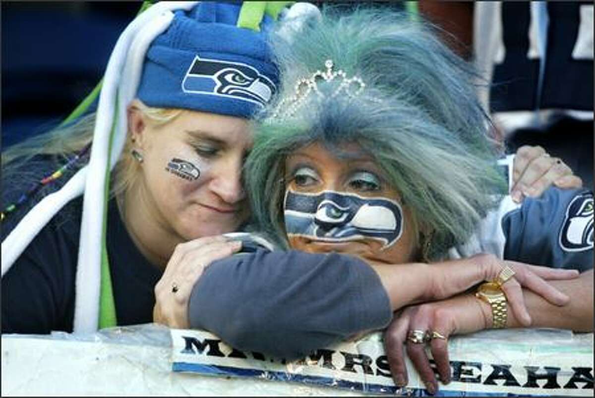 Seahawks fans Ronda Metzger, of Renton, left, and DeDe Schumaier, of Auburn, lament their team's sudden overtime loss to the Rams.