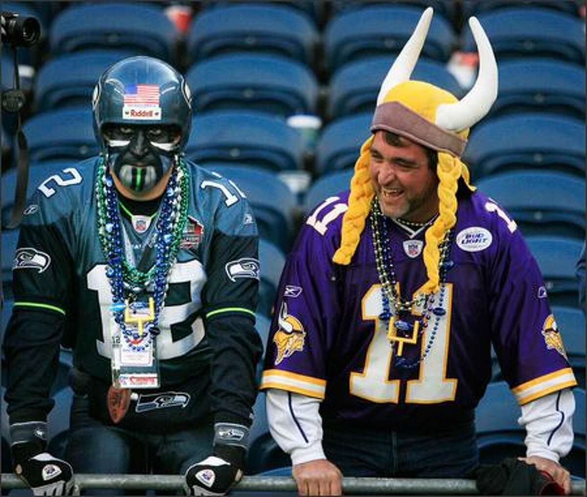 Seahawks fan Brad "Cannonball" Carter of Sumner glowers after the game, while Everett's Mark Gifford yuks it up after his Vikings' 31-3 victory Sunday.