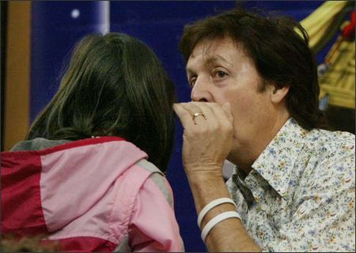 Paul McCartney whispers the ending of his new children's book in the ear of Jade Lauw, a second-grader at Briarcrest Elementary School in Shoreline, during a reading Friday at Third Place Books in Lake Forest Park. Also in attendance was one very excited P-I reporter ...