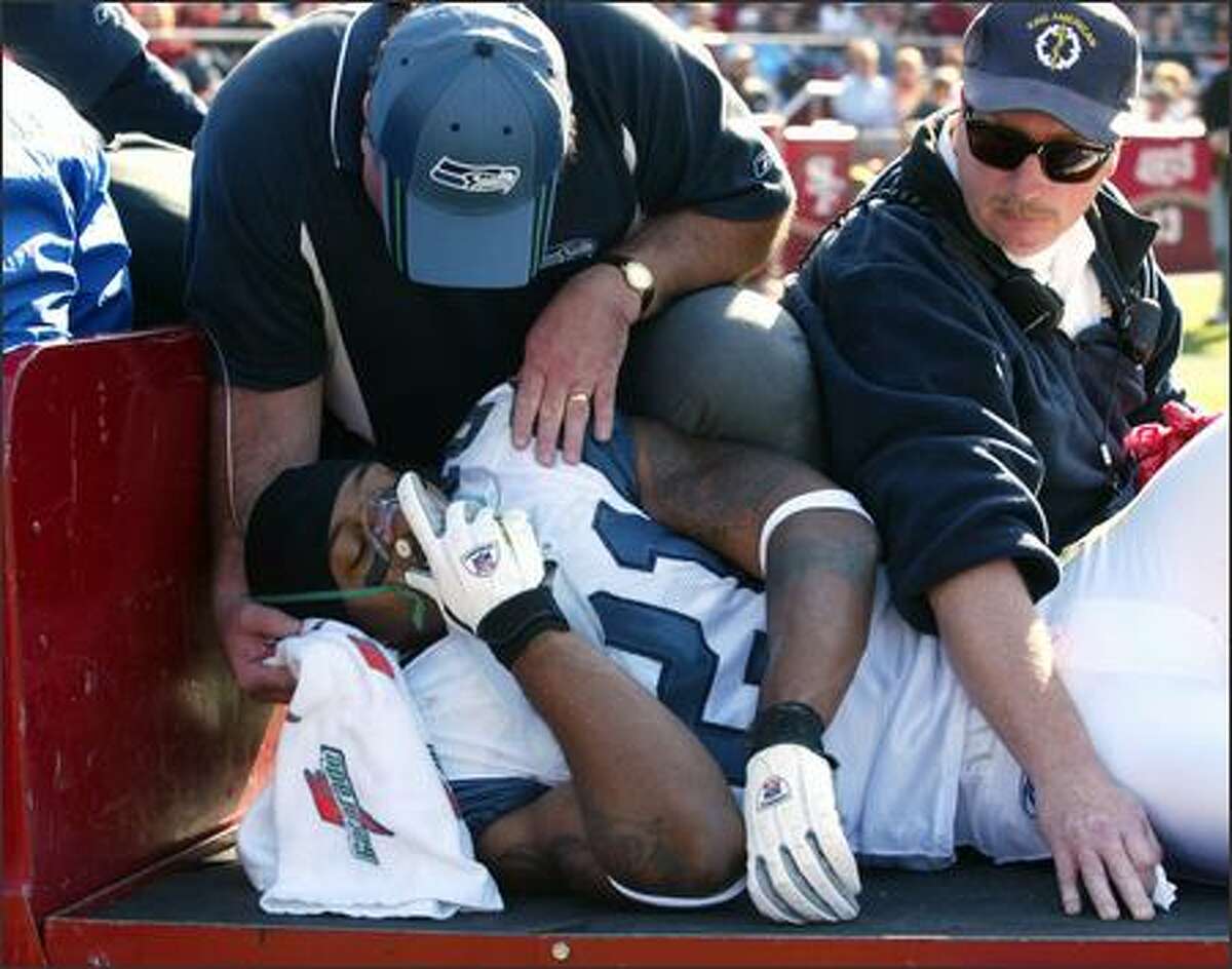 Seahawks cornerback Ken Lucas is carted off the field after getting injured.