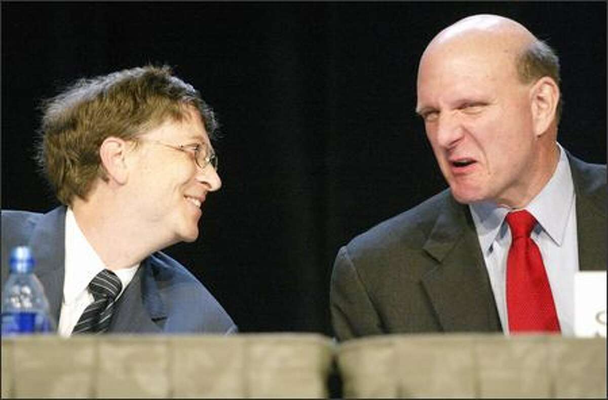 Microsoft's Bill Gates and Steve Ballmer appear at the company's annual shareholders meeting in Bellevue yesterday. Some in the audience had pointed questions about the stock's sluggish price.