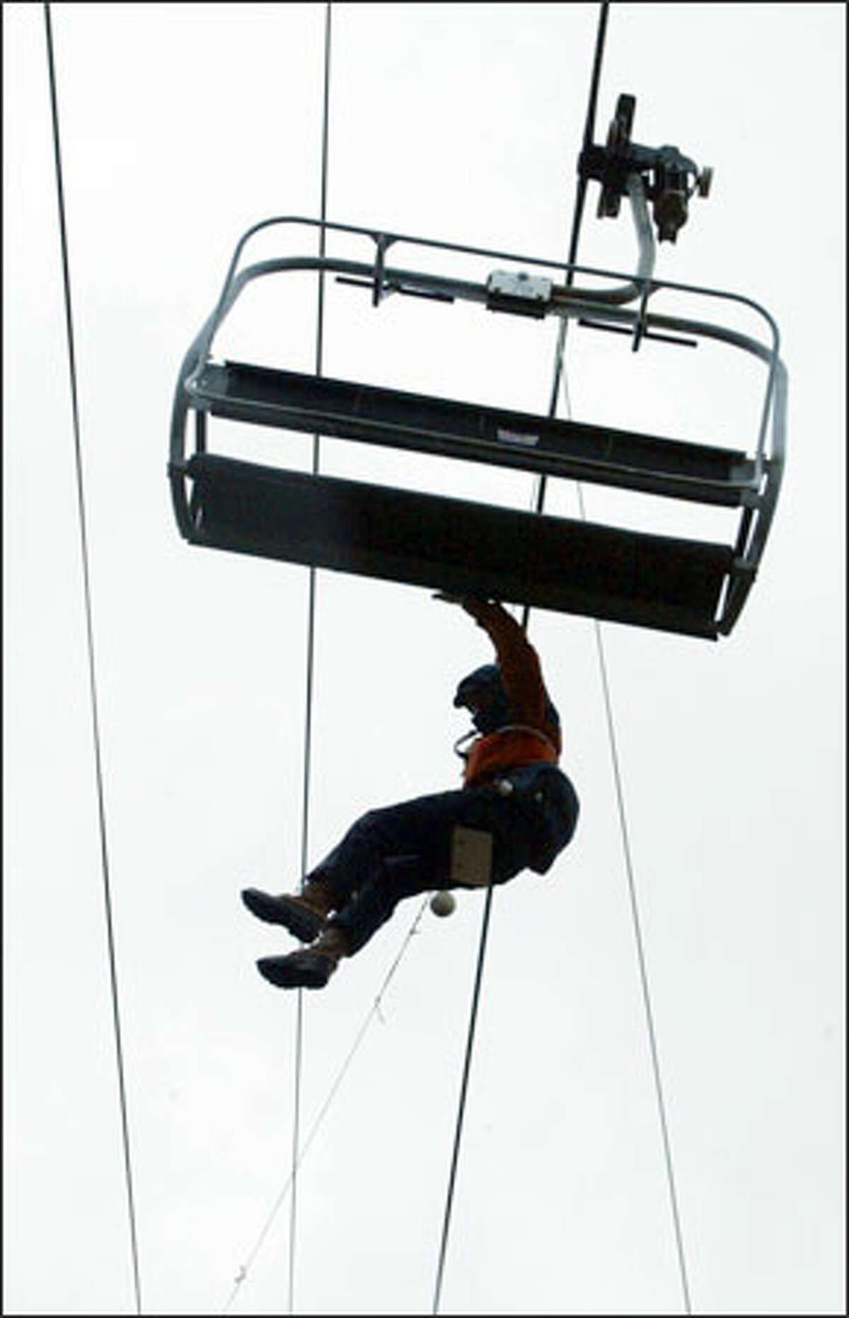 Dave Buck is lowered off the chairlift at Summit Central at Snoqualmie Pass during training exercises for volunteers. The chair evacuation is one of many skills that members of the ski patrol must learn.