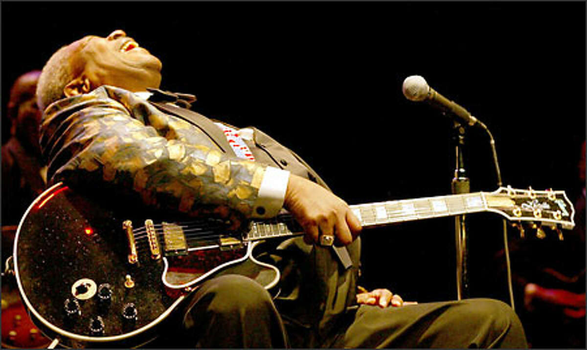 B.B. King's laughs as he talks about the clouds in Seattle touching the ground during a break between songs during the Mississippi-bred blues legend's performance at McCaw Hall Tuesday night. He's holding his famous guitar Lucille.