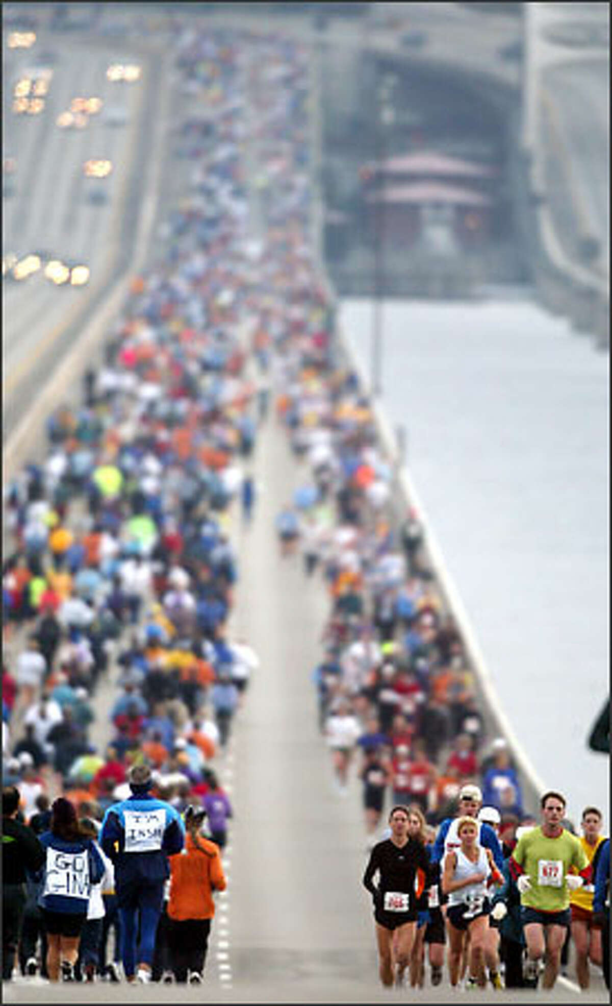 Runners make their way across the Interstate 90 bridge during the Seattle Marathon. More than 3,000 people participated in the 26.2-mile run, following a route from downtown Seattle to Mercer Island and back, then south on Lake Washington Boulevard, around Seward Park to Boylston Avenue East before heading for the finish at the Seattle Center.