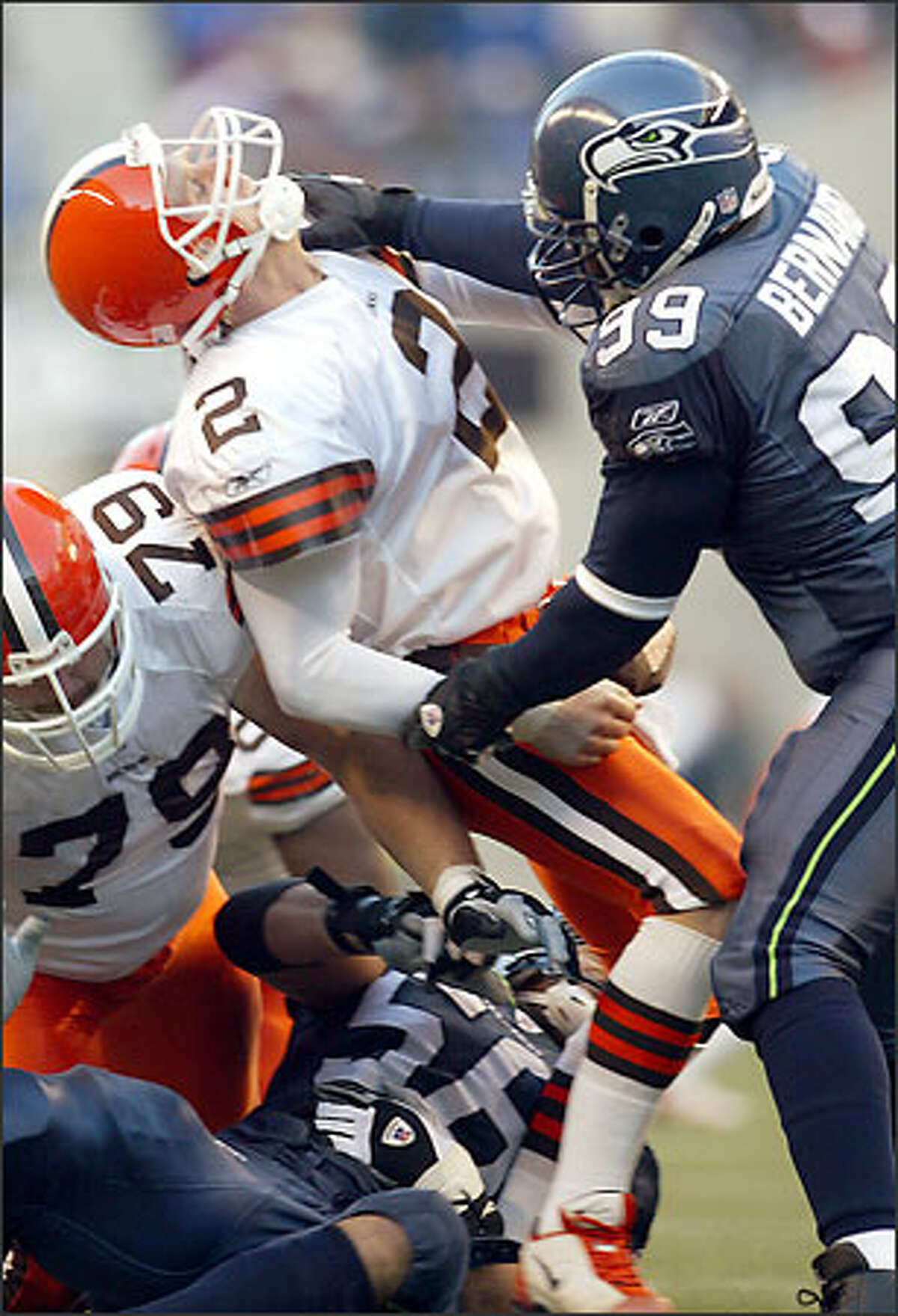 Seahawks DE Rocky Bernard, hitting Tim Couch high, and Chike Okeafor, hitting him low, knock the Browns quarterback out of the game.