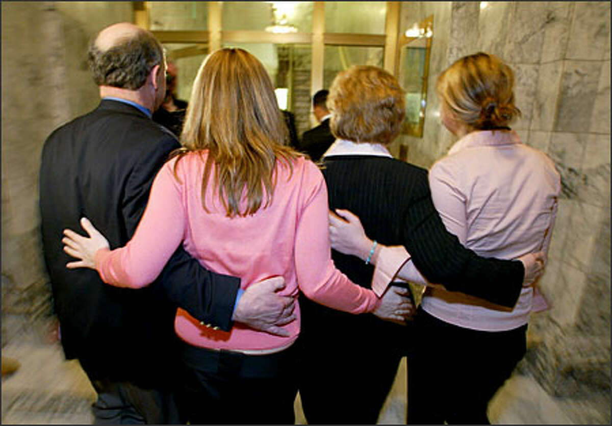 Christine Gregoire with her husband Mike, and daughters Courtney and Michelle exit a press conference in Olympia after expressing her gratitude for being in the lead of the governor's race.