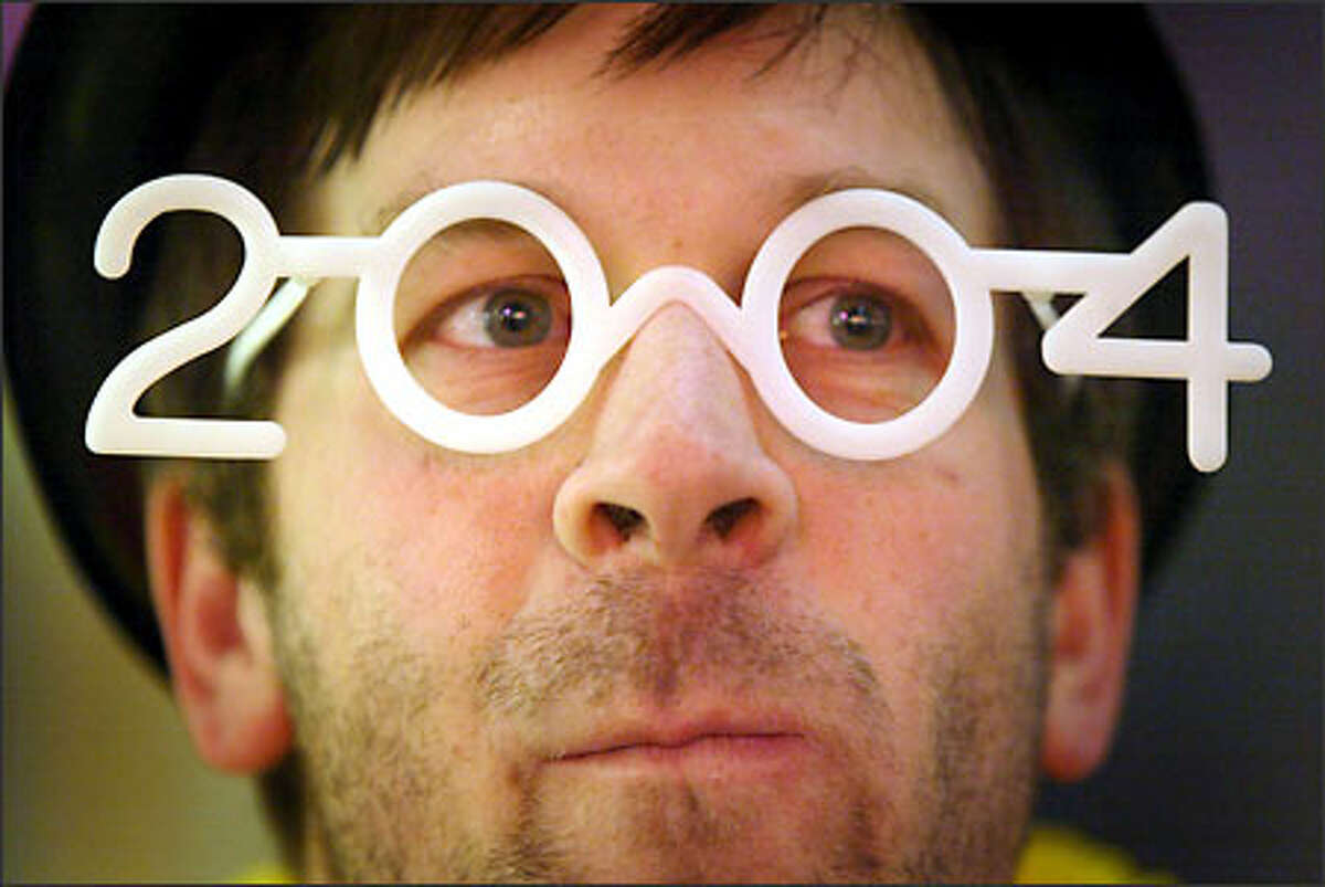 Mike J. Fischer sports a pair of 2004 glasses at the Seattle Center as the clock winds down toward the New Year.