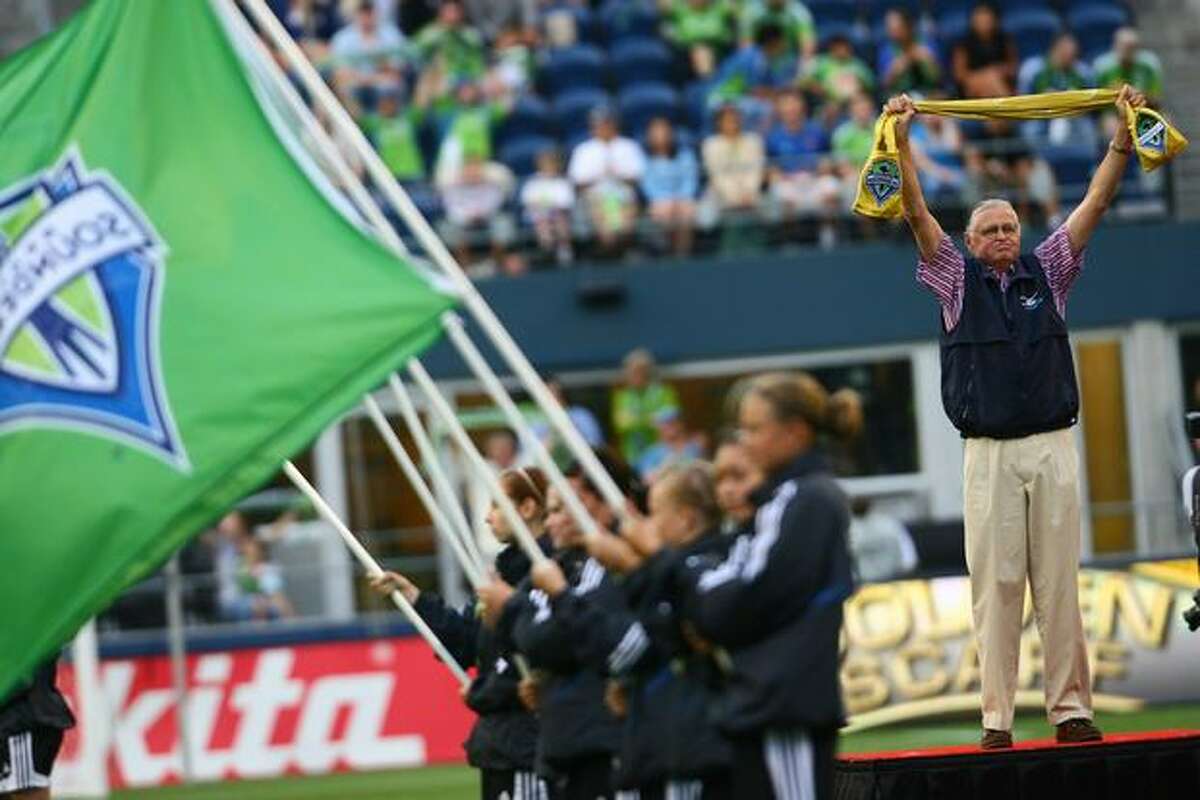 The Golden Scarf recipient waves to the crowd before the start of the match.