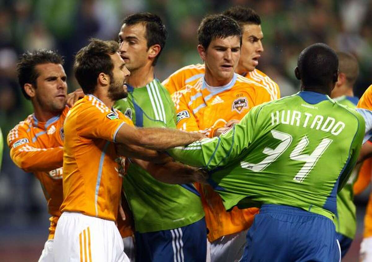 From left, Houston's Mike Chabala and Brian Mullan, Seattle's Patrick Ianni, Houston's Bobby Boswell and Geoff Cameron and Sounders player Jhon Kennedy Hurtado are involved in a shoving match that resulted in two yellow cards in the first half.