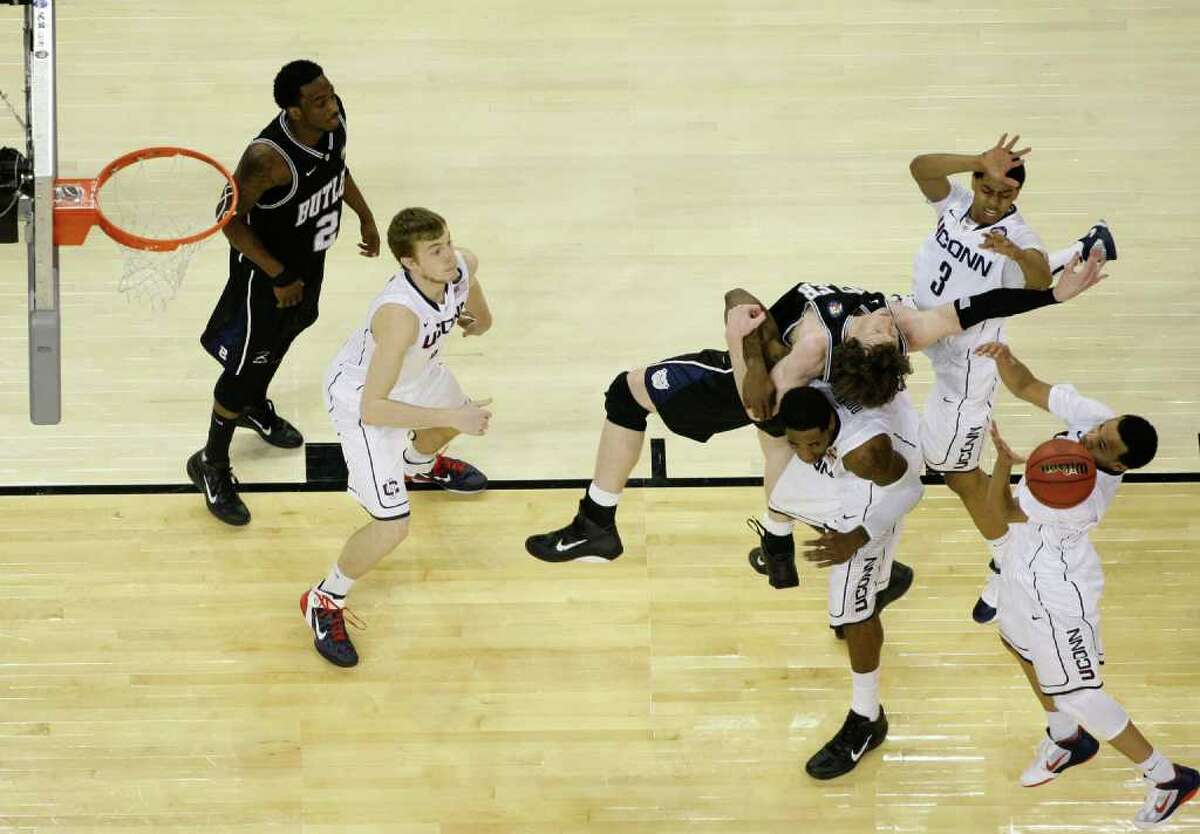Butler forward Matt Howard (54) battles for the ball against Connecticut forward Jeremy Lamb (3), Connecticut center Alex Oriakhi (34), (bottom) and Connecticut guard Shabazz Napier (13) during the second half as UConn defeated Butler 53-41 during the NCAA National Championship at Reliant Stadium on Monday, April 4, 2011, in Houston. ( Nick de la Torre / Houston Chronicle )
