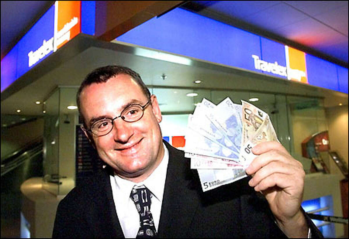 Trevor Mallard, New Zealand's associate minister of finance, displays the 225 euros he bought at a currency exchange at Wellington International Airport early today.