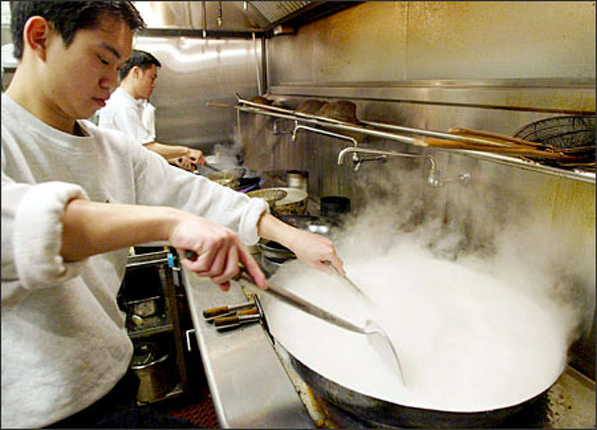 Phanxen Yoo makes coconut sauce at his family's restaurant, Malay Satay Hut in Seattle's International District. A sister restaurant operates in Redmond.