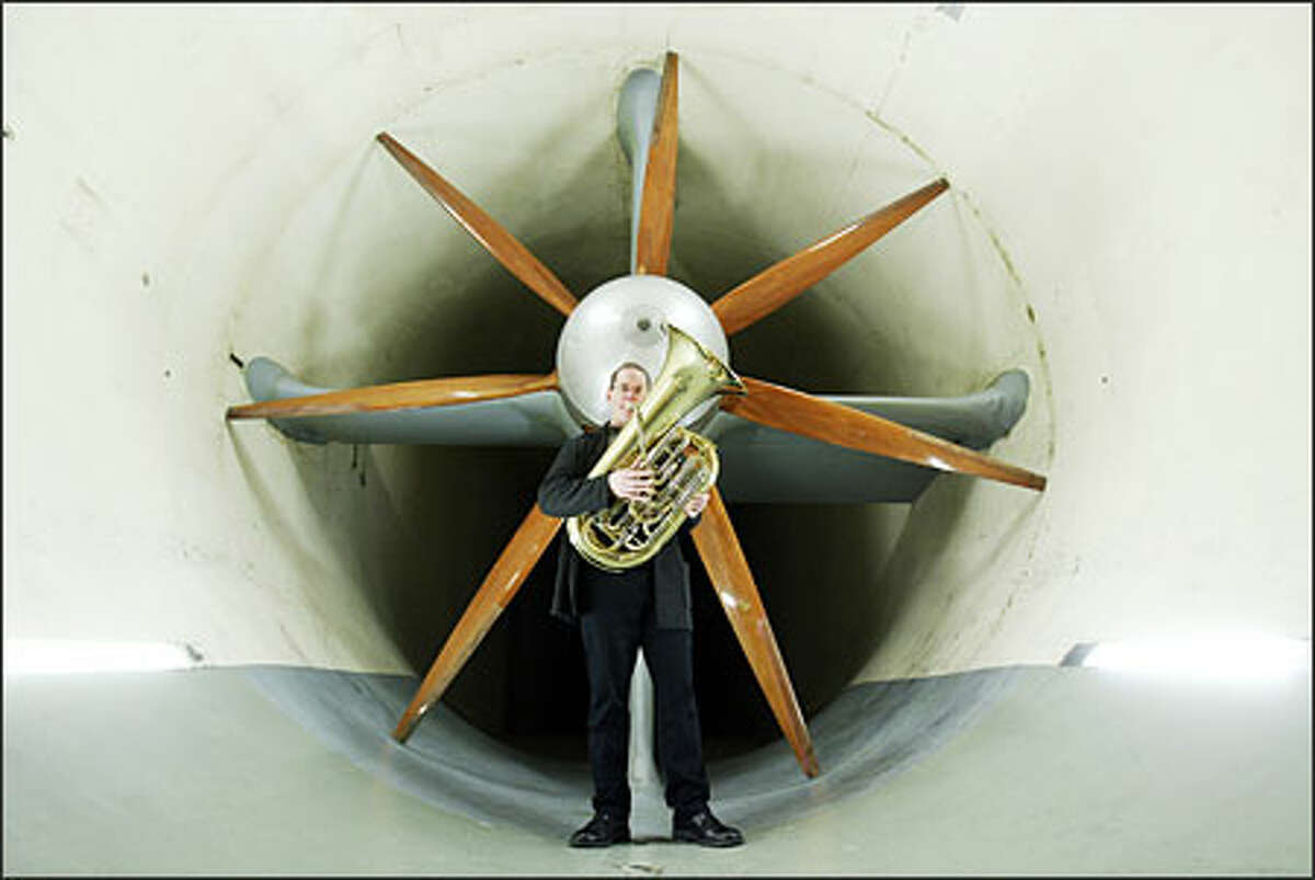 Seattle Symphony principal tuba player Christopher Olka stands in the F.K. Kirsten Wind Tunnel where the late Boeing engineer -- and tuba player -- James Crowder once worked. Samuel Jones, whose concerto was commissioned in Crowder's memory, wants to replicate the tunnel's "huge, compelling sound."