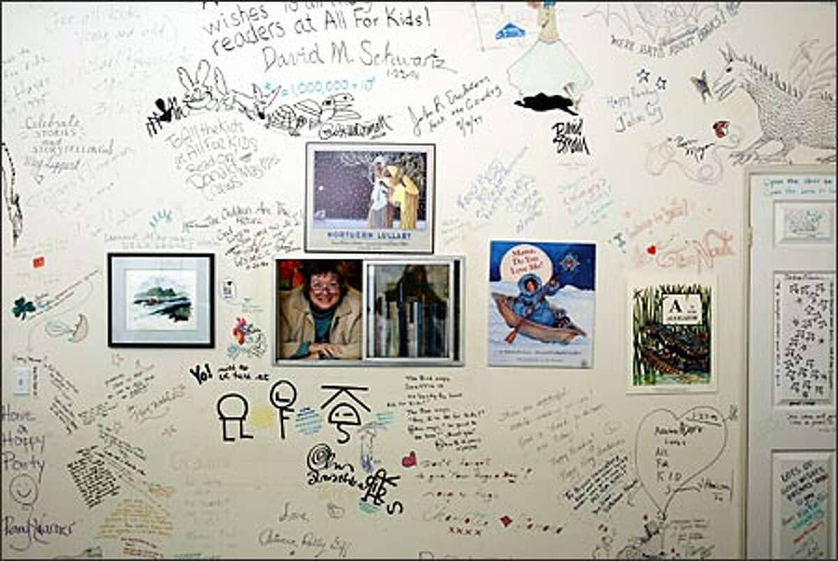Hundreds of children's book authors and illustrators have saturated the walls of the All For Kids Books & Music event room with their signatures and drawings.