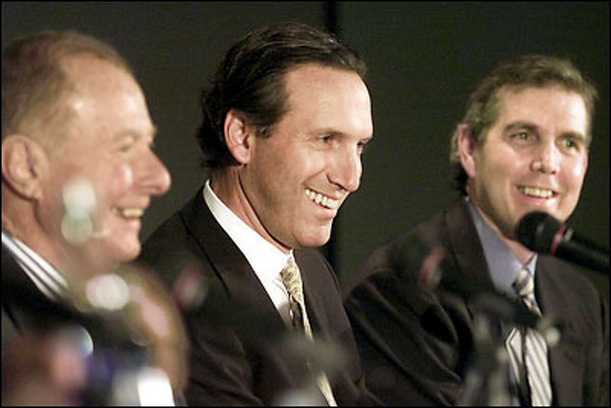 A group including Howard Schultz, center, and Sonics President and GM Wally Walker, right, bought the team from Barry Ackerley.