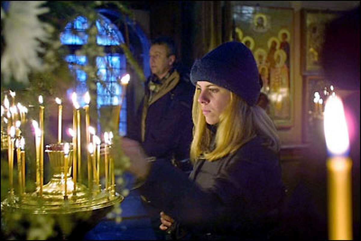 A Russian woman lights a candle in the Kazan Church on the Red Square in Moscow. Russians celebrated Old New Year’s Eve yesterday. The holiday is based on an old calendar used by the Orthodox Church, and it has become increasingly popular among believers who can’t fully celebrate the real New Year’s Eve on Dec. 31 because of a religious fast. Champagne, wine and vodka are in order, and many have a toast at midnight, just as most people do on New Year’s Eve.