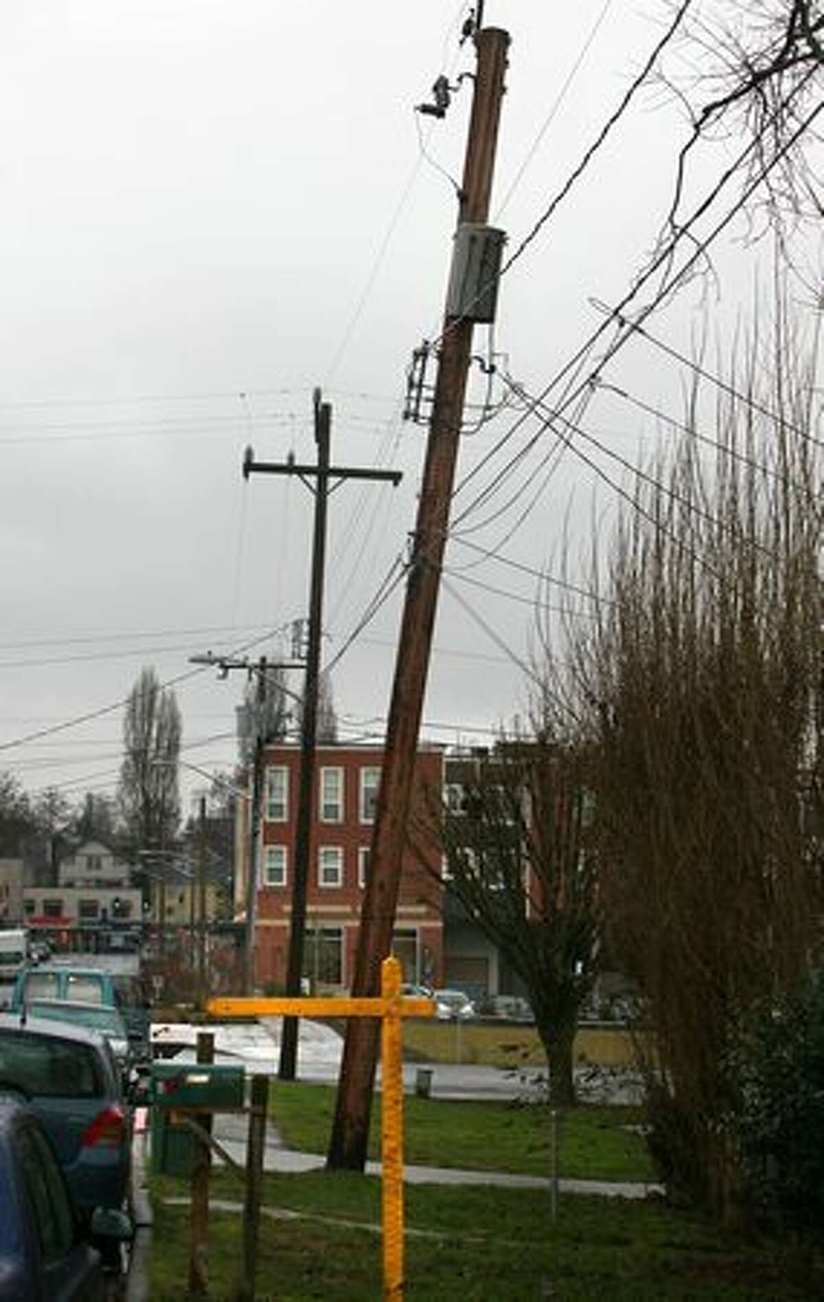 A telephone pole slowly sinks into the ground on Palatine Avenue North.