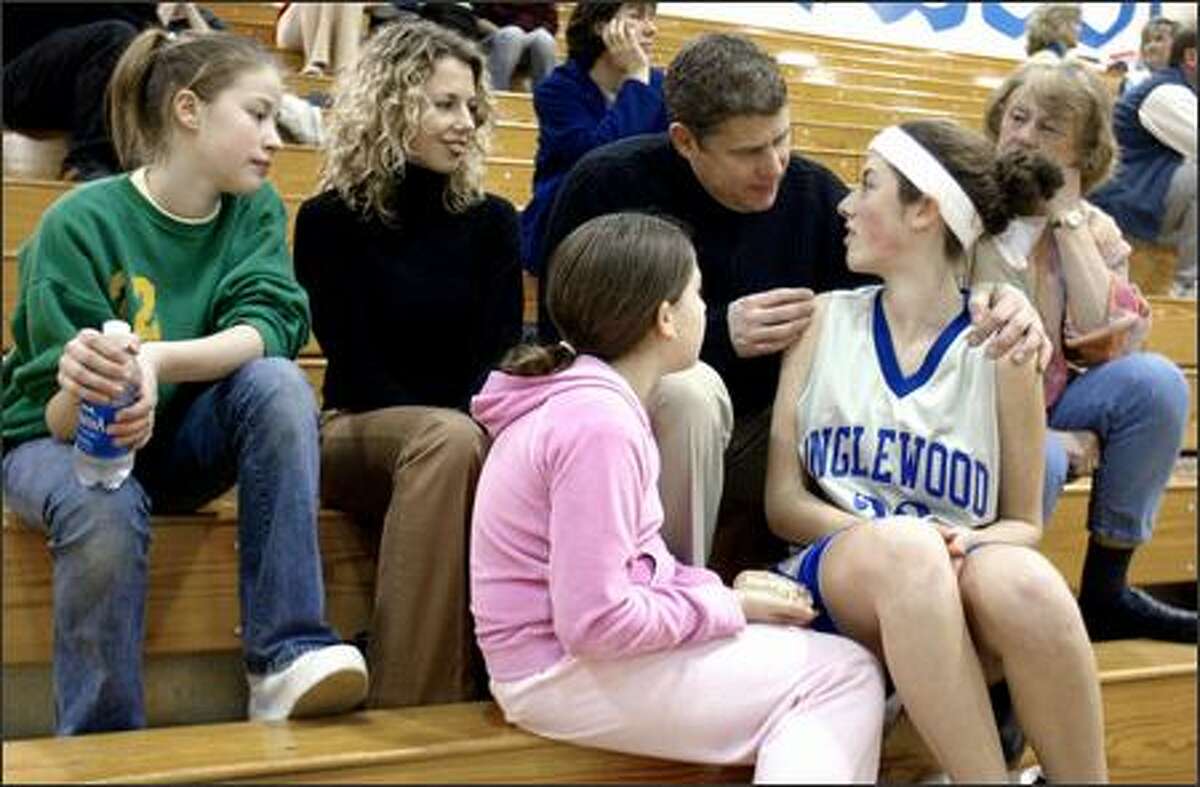 John Greig, agent and entrepreneur, gives daughter Cristina some encouragement before a middle school game. With Greig are wife Kirsten, daughters Alysha, left, and Noelle, and mother Betty Foose, right.