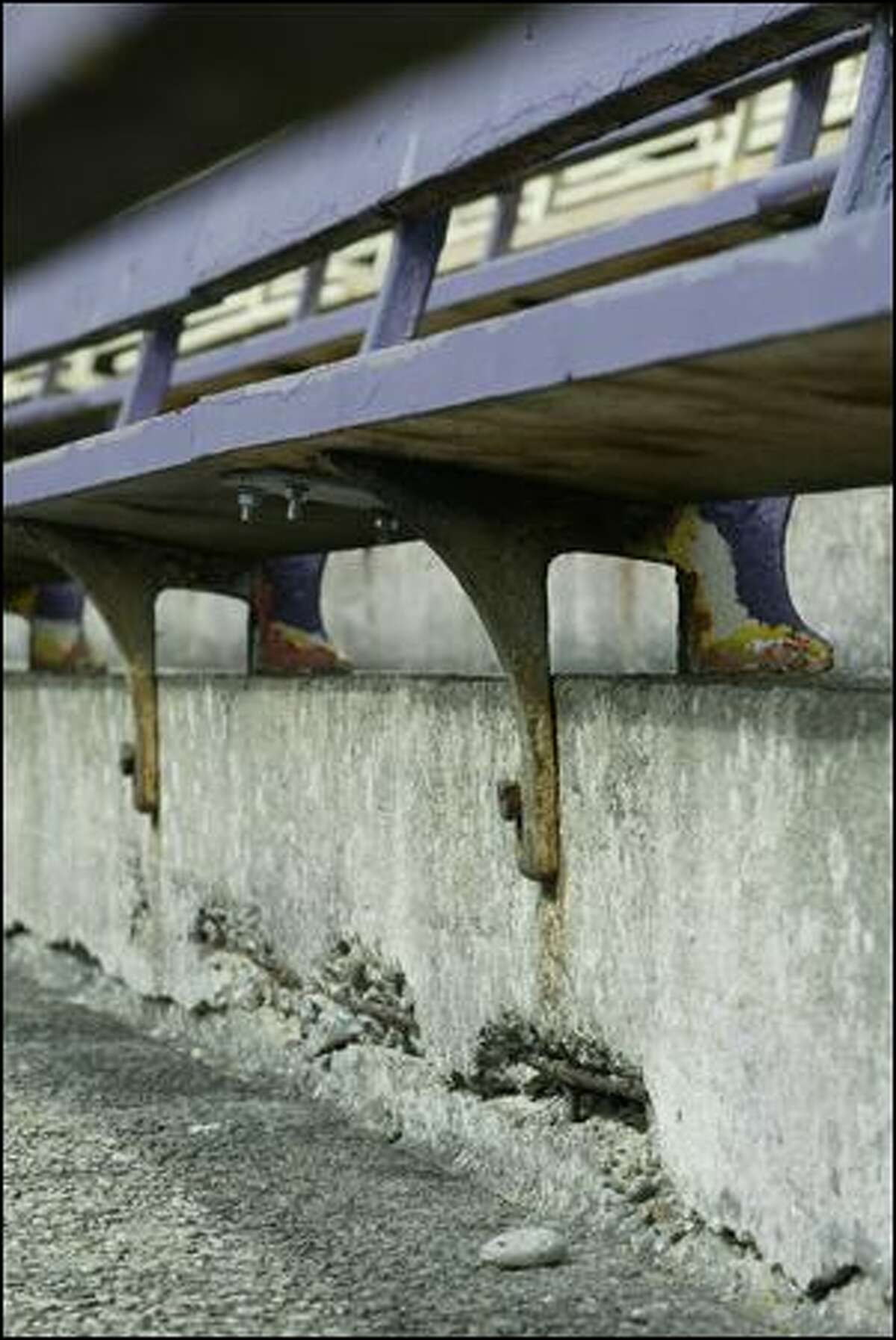 Lateral cracks in the concrete that makes up the lower bowl of Husky Stadium can be seen beneath the bleachers. (P-i File / 2007)