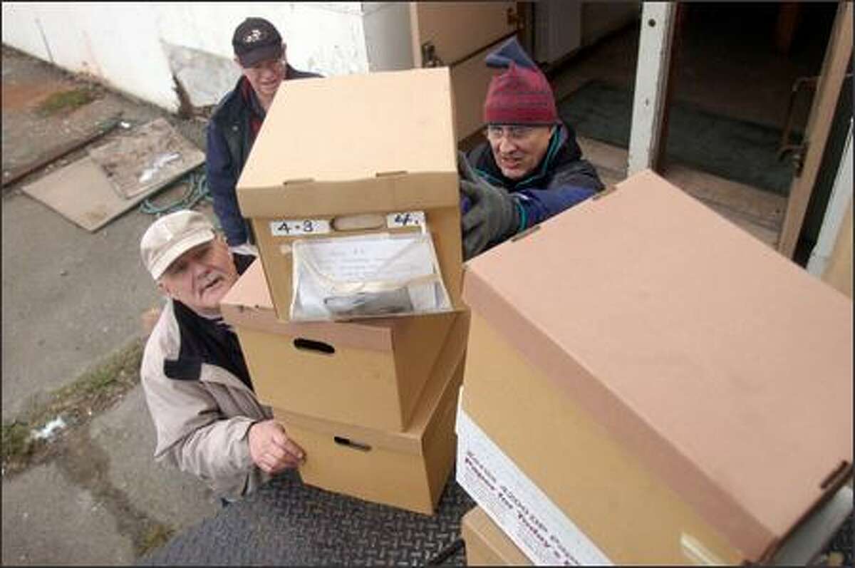 Volunteers, from left, Michael Hansen, Bill Milne and Gary Long help move Highline Historical Society's museum collection to Seattle Christian School's old building.