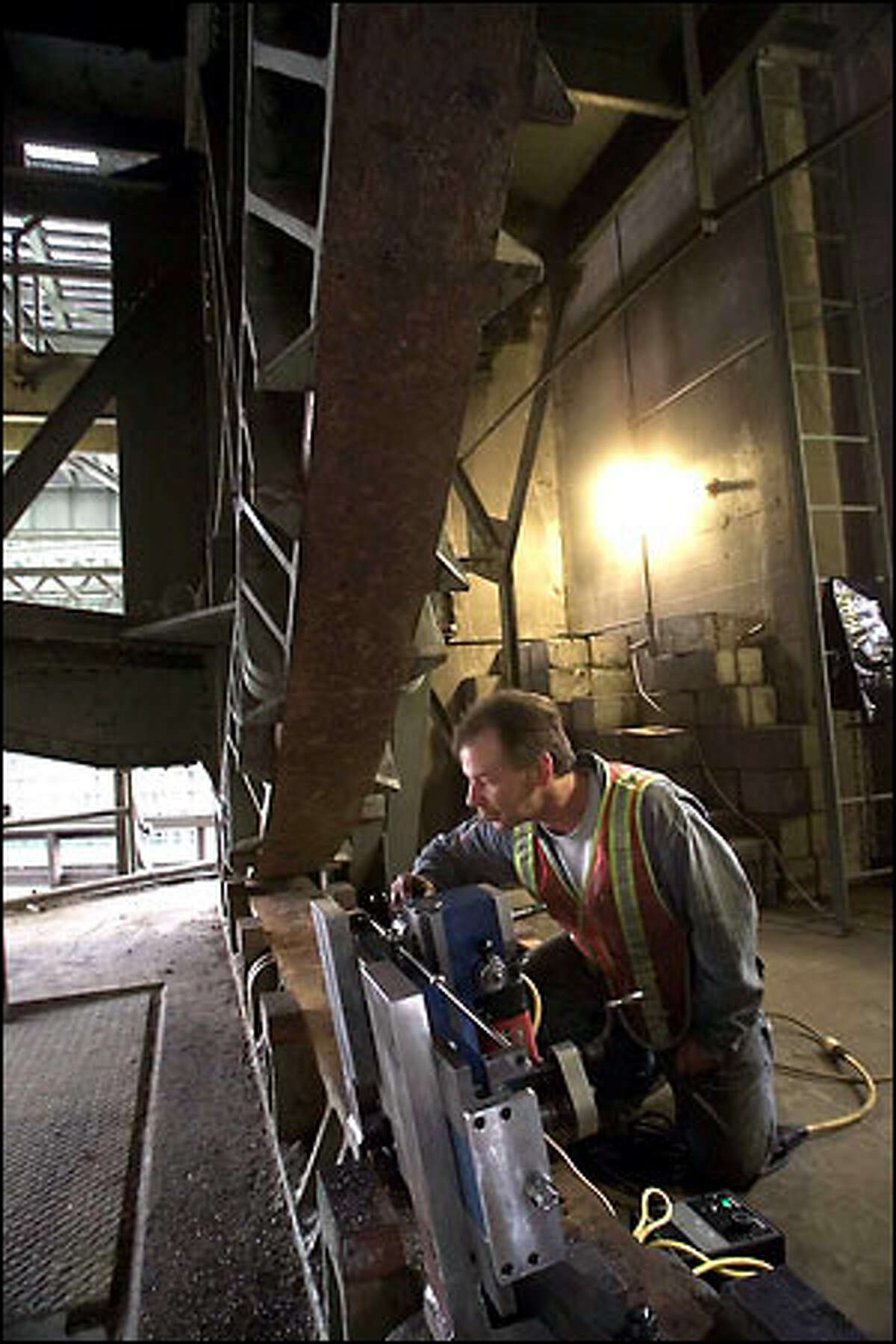 Machinist Justin Killingbeck mills lugs to help realign the drawspan section of the South Park Bridge.