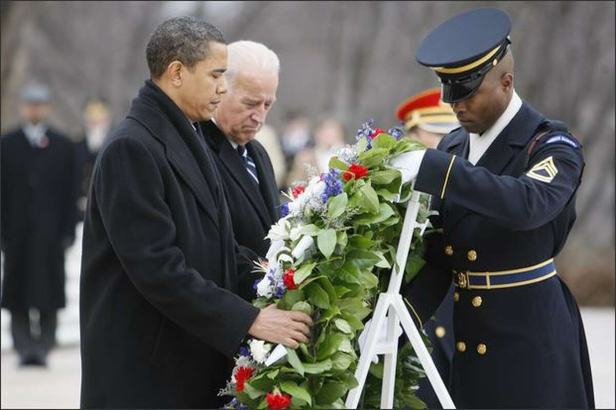 President-elect Barack Obama and Vice President-elect Joe Biden lay a wreath at the Tomb of the Unknowns at Arlington National Cemetery in Arlington, Va., on Sunday.