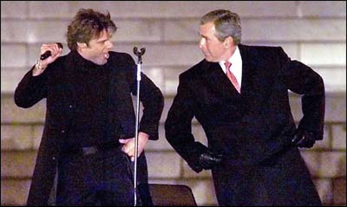 President-elect George W. Bush and singer Ricky Martin share the stage and a few moves in the Inaugural Opening Celebration yesterday at the Lincoln Memorial. While some discussed Bush’s environmental stands, most in Washington, D.C., were preparing for weekend inaugural activities.