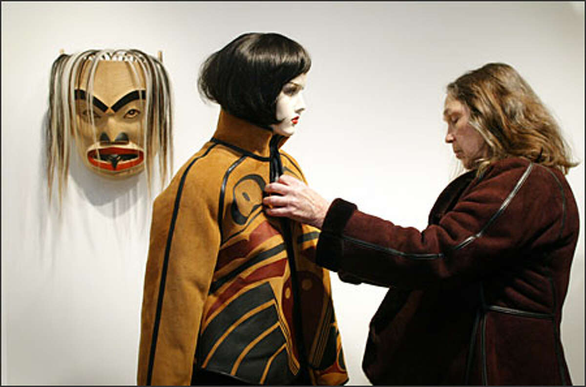 Betty David dresses a mannequin in one of her Port Madison hand-painted shearling coats in her new Pike Place Market shop.