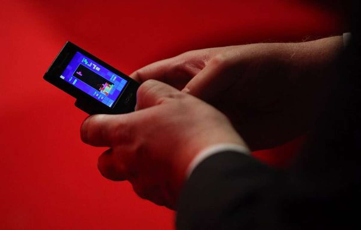 A delegate plays a game of Tetris on his mobile phone during the speeches on the fourth day of the Labour Party Conference on Sept. 30, 2009 in Brighton, England.
