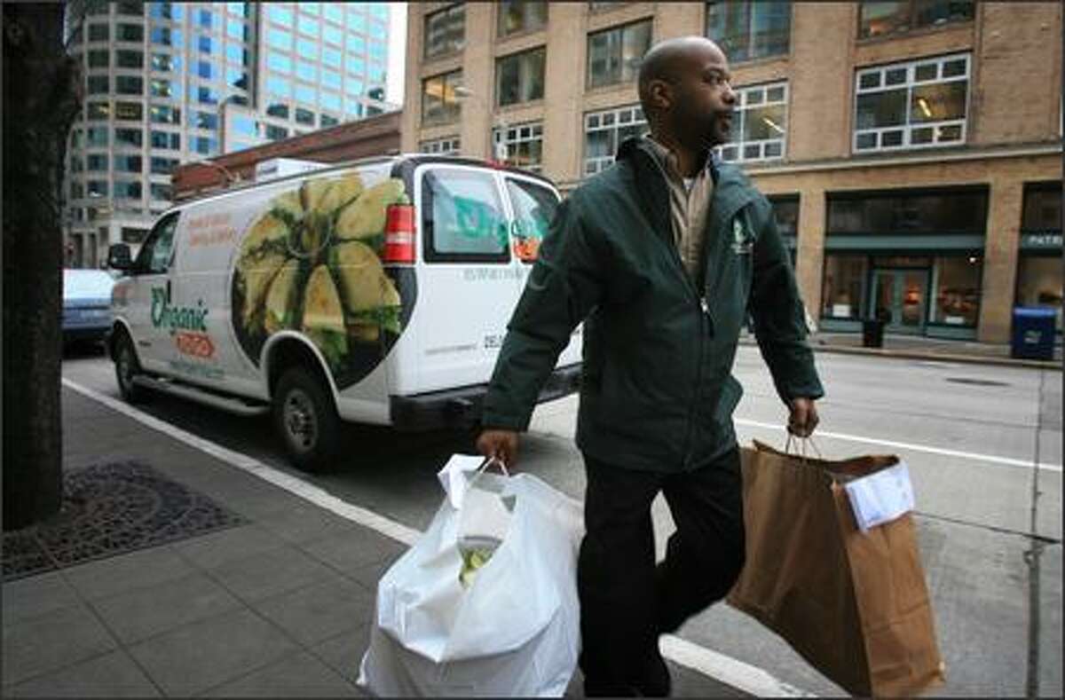 Organic To Go employee John Wheeler makes a lunch delivery in downtown Seattle. The company has cafes and offers catering from Western Washington to Southern California.