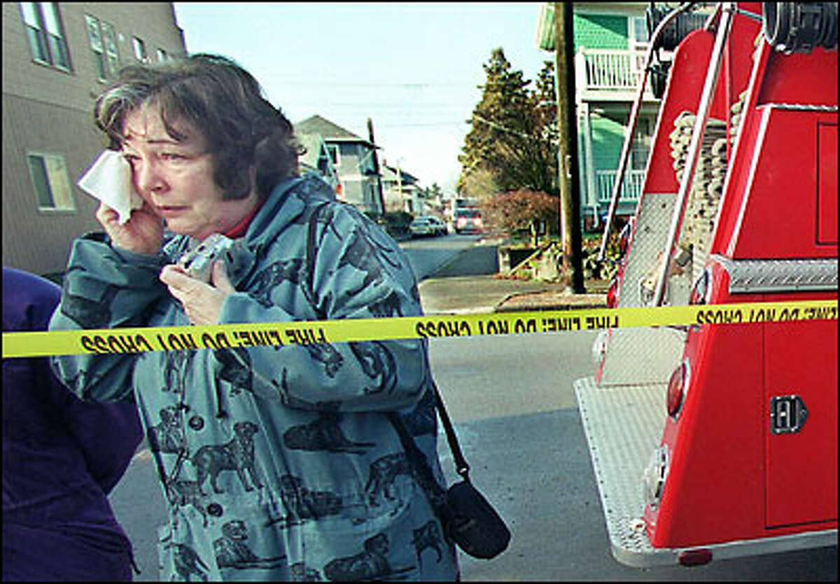 Kay Morrison, whose children attended Coe Elementary School, wipes away tears yesterday after viewing the ruins of the venerable Queen Anne institution, destroyed by fire early Sunday. "It was a content old place with memories you could feel when you sent inside," she said. Investigators were trying to pinpoint cause of the blaze.