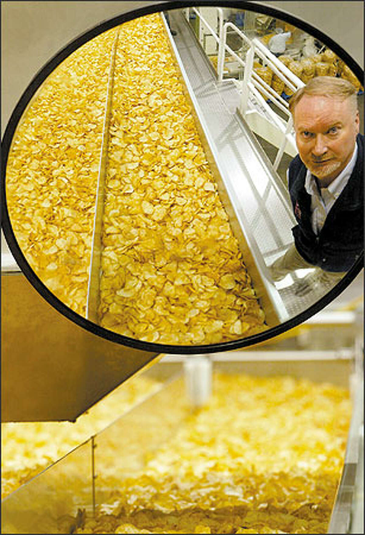 Tim Kennedy, the founder of Tim's Cascade, is reflected in a mirror as his potato chips pass by on their way to be seasoned. Original and Hot! Jalapeño flavors are always the top sellers, but Cracked Peppercorn is getting recent publicity.