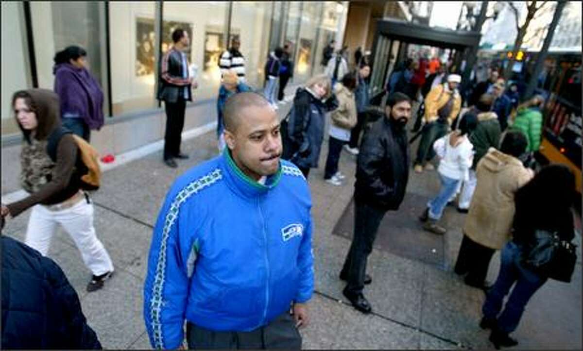Andre Burshain sports Seahawks colors Tuesday on Third Avenue, but not many others were. Downtown was largely devoid of team paraphernalia.