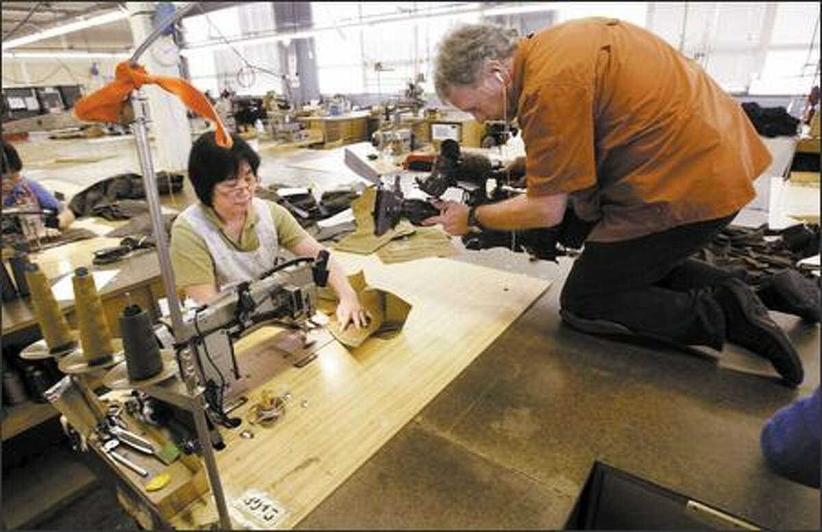 Wes Dorman, director of photography for "John Ratzenberger's Made in America," films seamstress Yue Na Liao in the Filson production facility Wednesday.