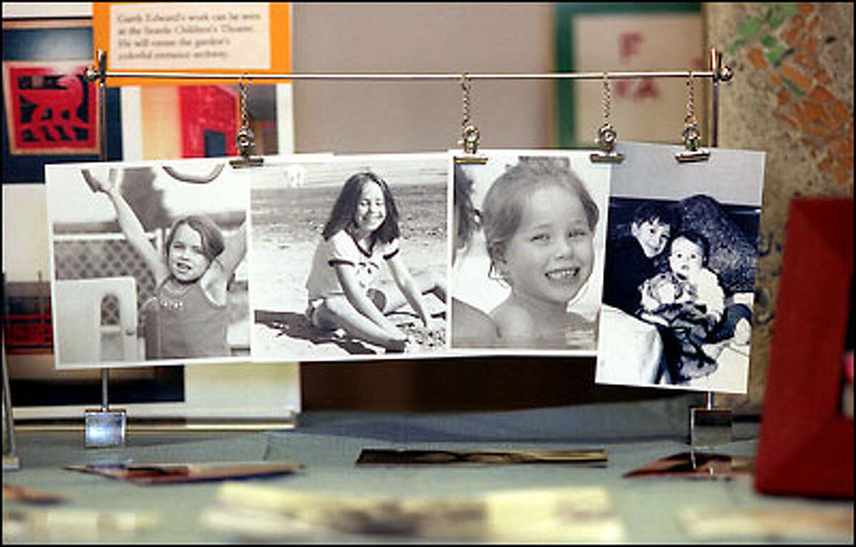 Photographs of the four John Hay Elementary students who were killed on board Flight 261 one year ago are mounted on a table at the school. From left: Blake and Coriander Barnett-Clemetson, Rachel Pearson and Miles J. Clemetson, shown with his 6-month-old brother, Spencer, who also died in the crash.