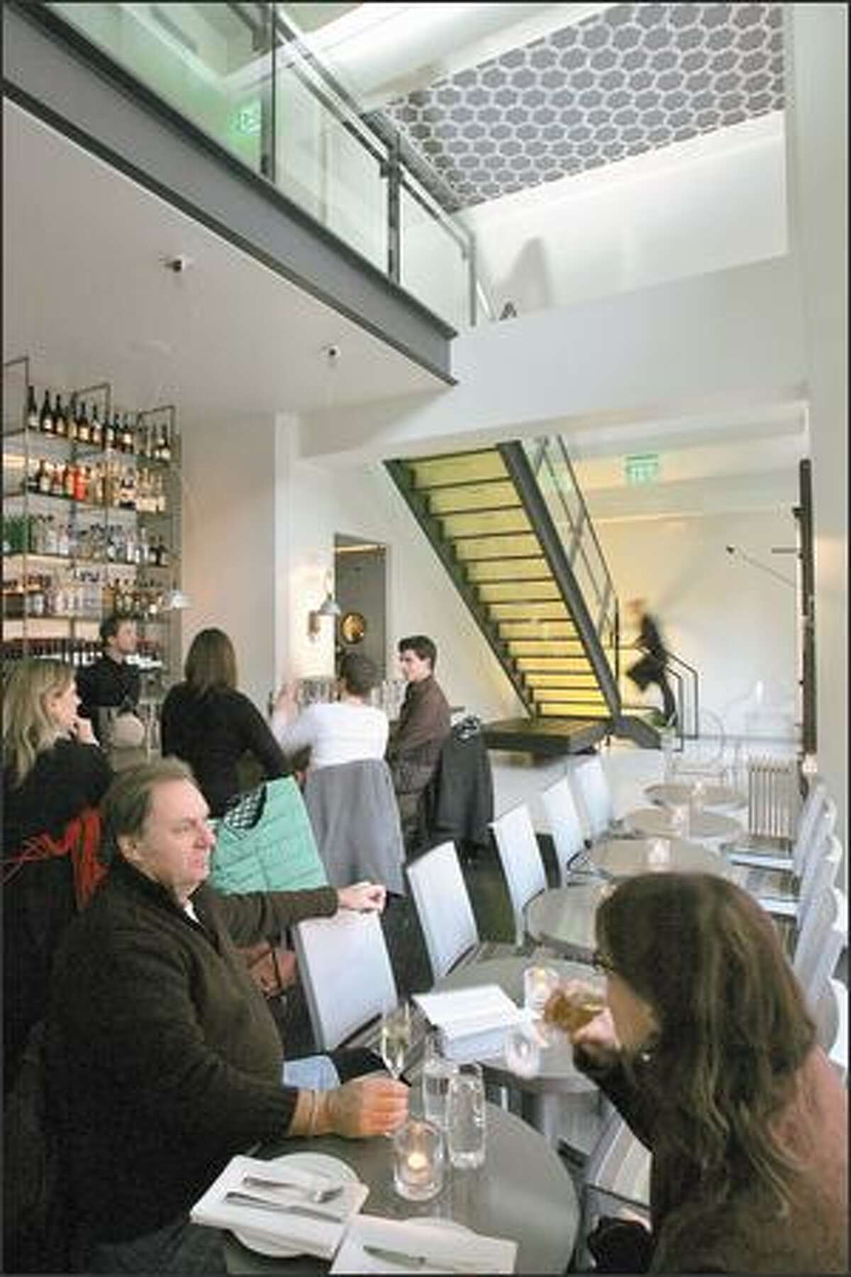 Vessel's entryway is bisected by an acid-yellow glass staircase. The first nine of the menu's 11 pages are dedicated to cocktails, straight pours and beer and wine.
